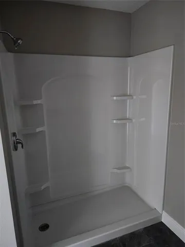 a bathroom with a glass shower door