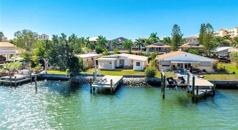 a backyard of a house with yard table and chairs