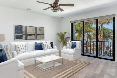 a living room with furniture and large windows