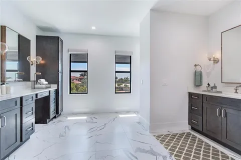 a spacious bathroom with a sink double vanity and a shower
