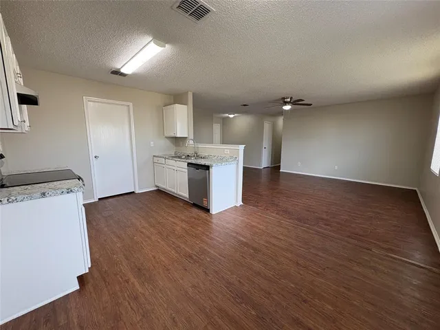 a view of a kitchen with a sink and a stove top oven