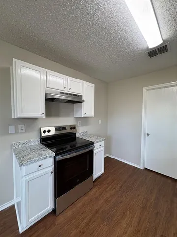 a kitchen with stainless steel appliances granite countertop a stove and a sink