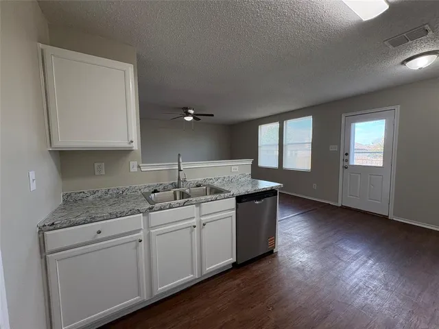 a kitchen with sink and cabinets