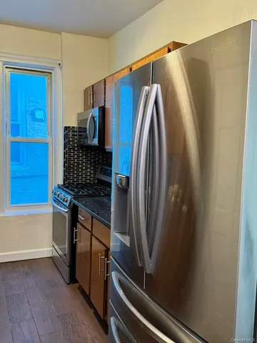 a view of a refrigerator and wooden floor