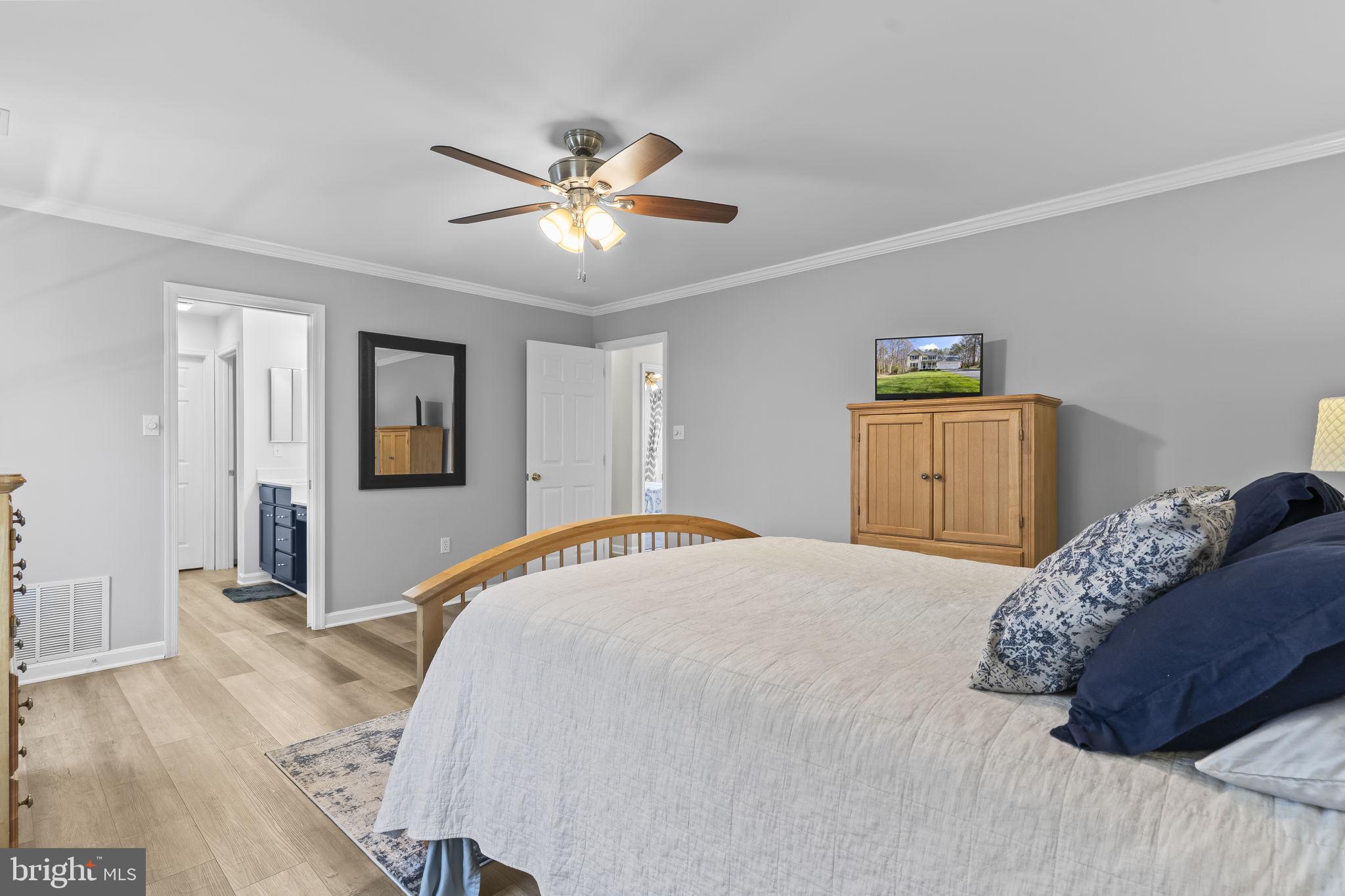 2132 Brians Way Lusby, MD 20657 - Photo 13 of 36 Serene bedroom with modern charm.