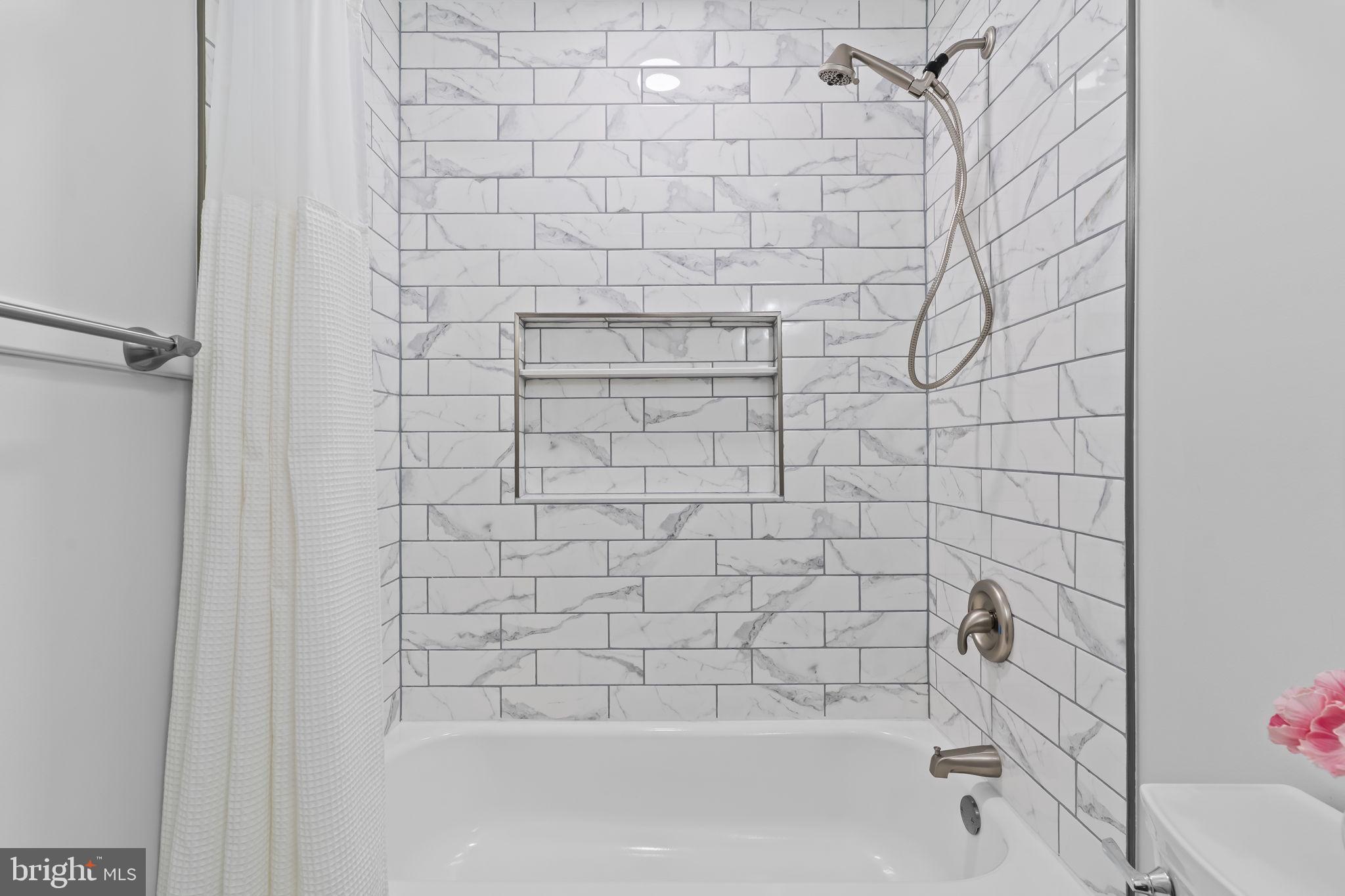 2132 Brians Way Lusby, MD 20657 - Photo 22 of 36 Sleek marble-tiled shower retreat.