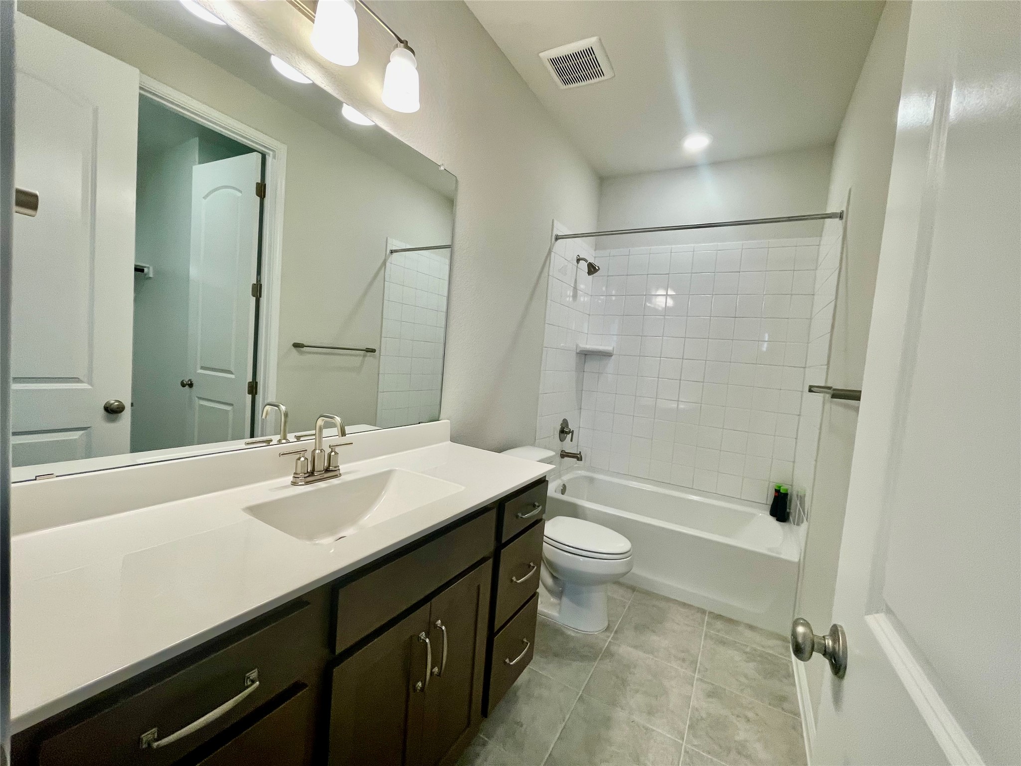 232 Denali Way Dripping Springs, TX 78620 - Photo 25 of 35 Full bath featuring vanity, bathing tub / shower combination, and light tile patterned flooring