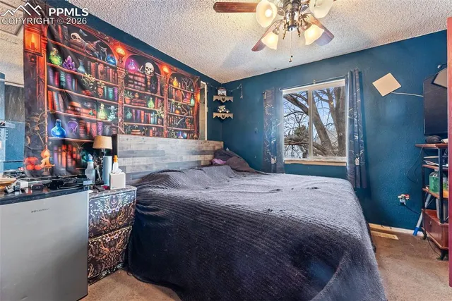 a bedroom with a bed and a large window