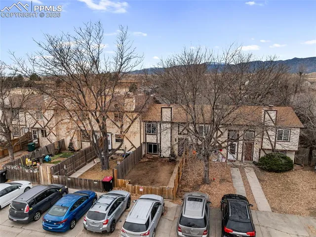 a view of a house with a large tree