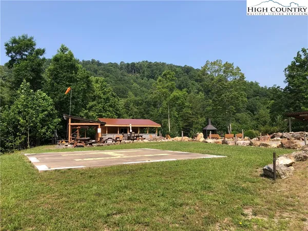 a view of backyard with wooden deck and outdoor seating