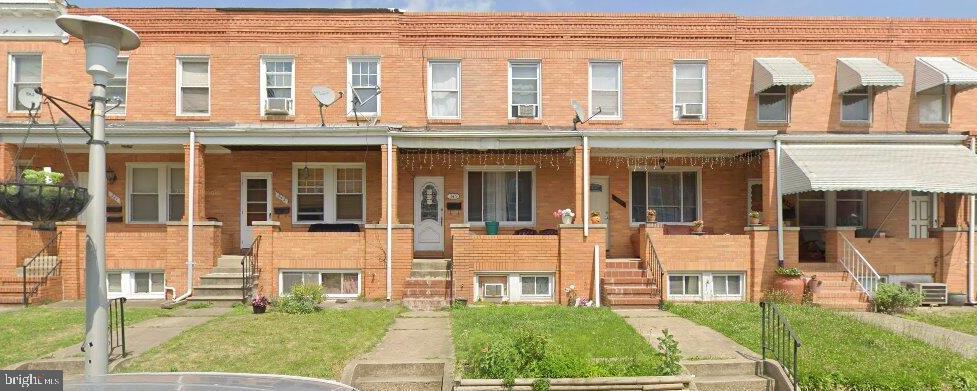 343 Folcroft Street Baltimore, MD 21224 - Photo 1 of 1 front view of a building with a yard