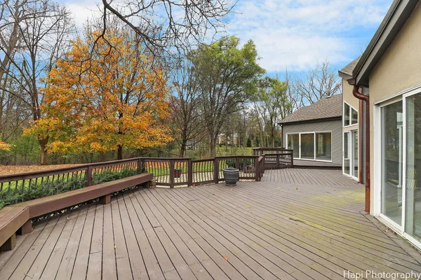 a view of a house with wooden deck and sitting area