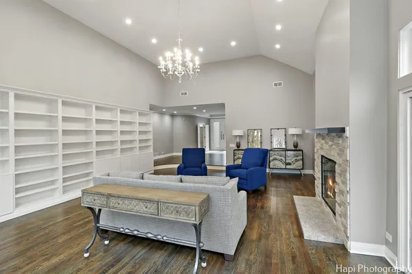 a living room with furniture and a chandelier