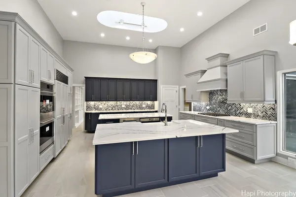 a kitchen with stainless steel appliances a stove sink and cabinets