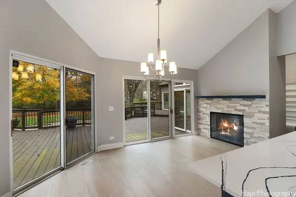 a view of a livingroom with a fireplace wooden floor and windows