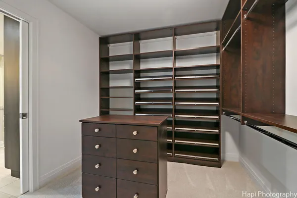 a view of walk in closet with empty racks