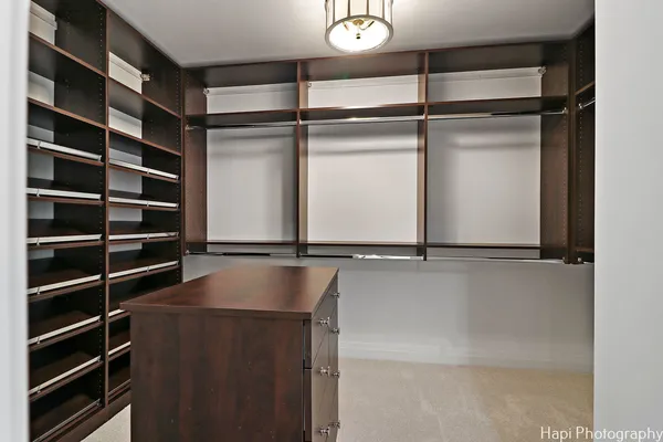 a view of walk in closet with empty racks