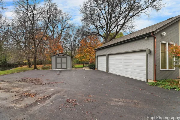 a view of a house with a yard and garage