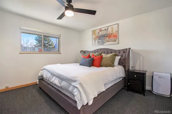 a bed sitting in a bedroom next to a window