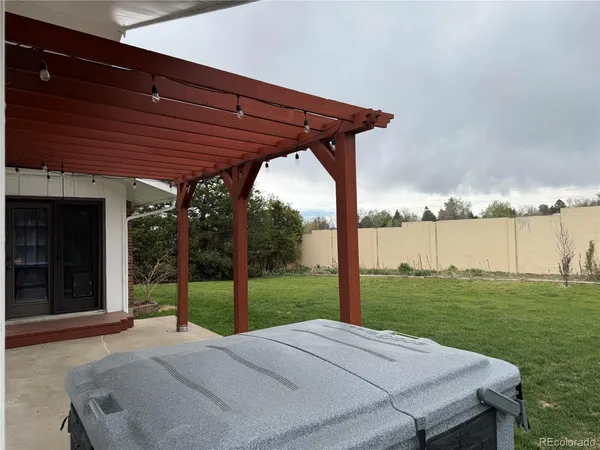 a view of a patio with a table and chairs under an umbrella