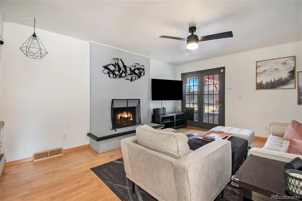 a living room with furniture and a fireplace