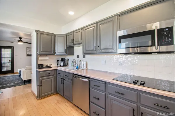 a kitchen with stainless steel appliances granite countertop a sink a stove a microwave and cabinets