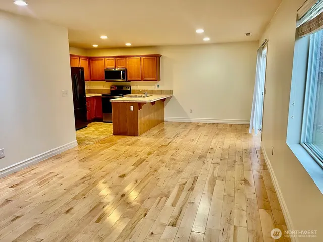 a kitchen with stainless steel appliances a refrigerator and a microwave