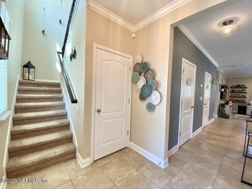 115 Sierras Loop St. Augustine, FL 32086 - Photo 33 of 65 a view of a hallway with entryway and stairs