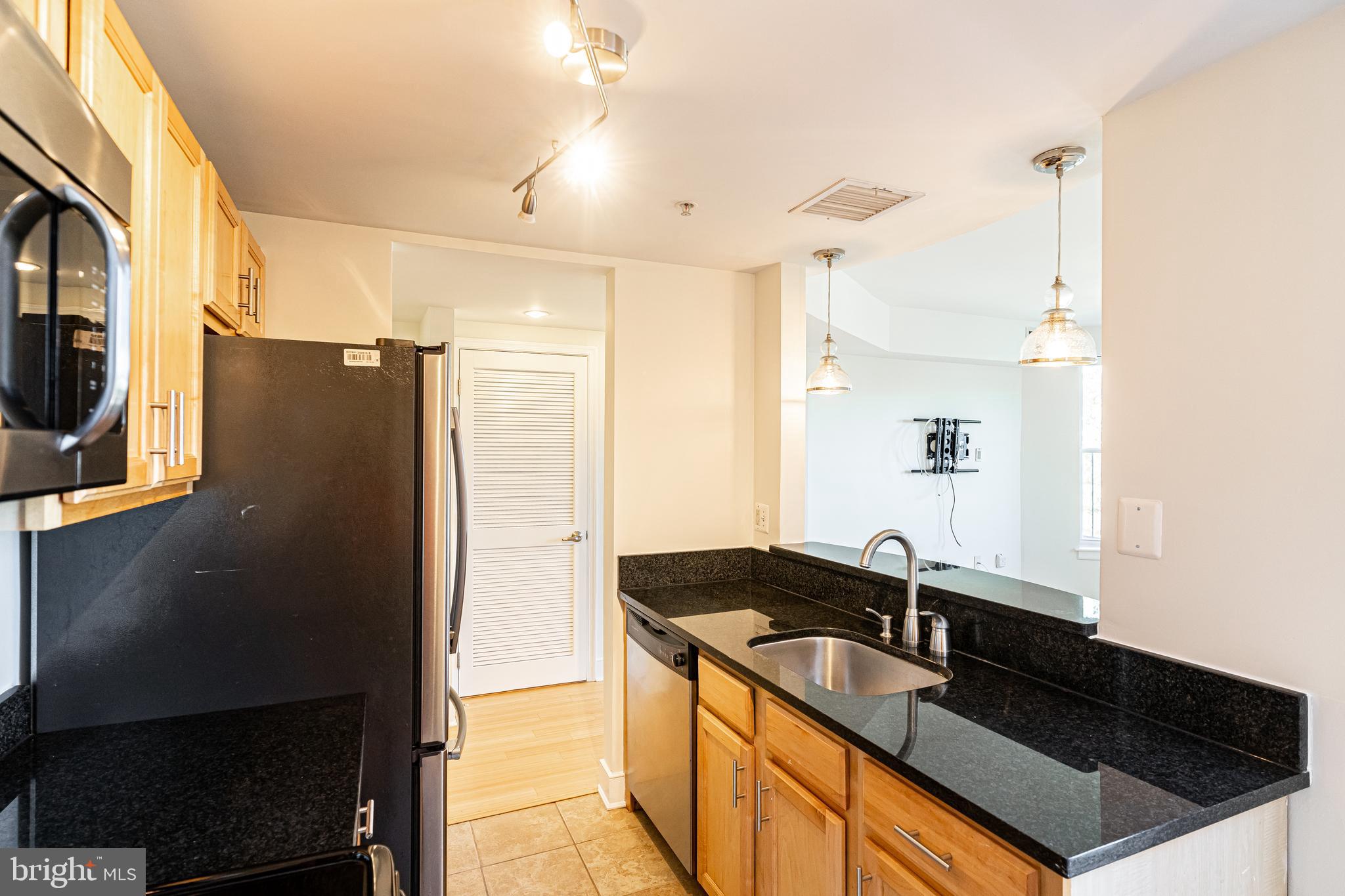 1108 Columbia Road Northwest, Unit 301 Washington, DC 20009 - Photo 9 of 20 Granite counters and light wood cabinets