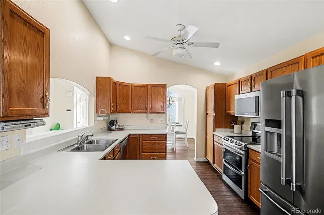a kitchen with stainless steel appliances a refrigerator sink and stove
