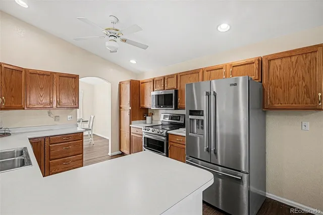 a kitchen with stainless steel appliances a refrigerator sink and cabinets