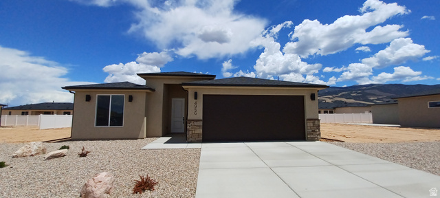 4956 North 925 East, Unit 87 Enoch, UT 84721 - Photo 2 of 19 Contemporary stucco exterior with stone accents and an attached two-car garage