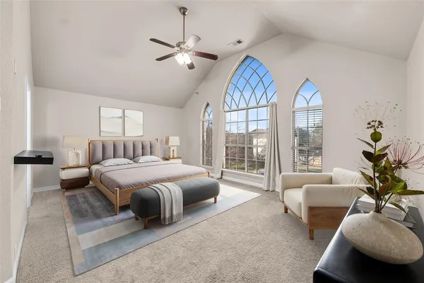 a spacious bedroom with a bed and a chandelier