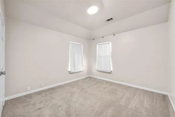 an empty room with a empty space and windows