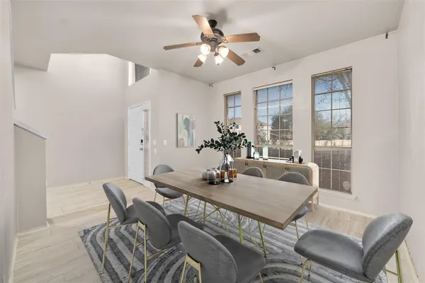 a dining room with furniture and window