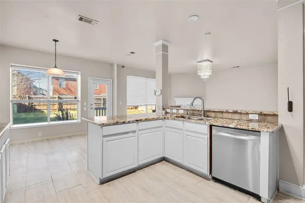 a kitchen with sink stove and cabinets