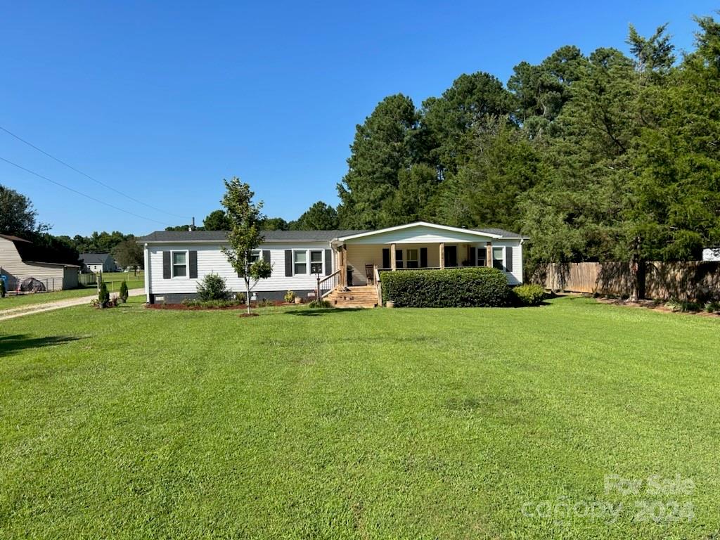 3250 Ferguson Long Road York, SC 29745 - Photo 2 of 32 a front view of a house with a garden