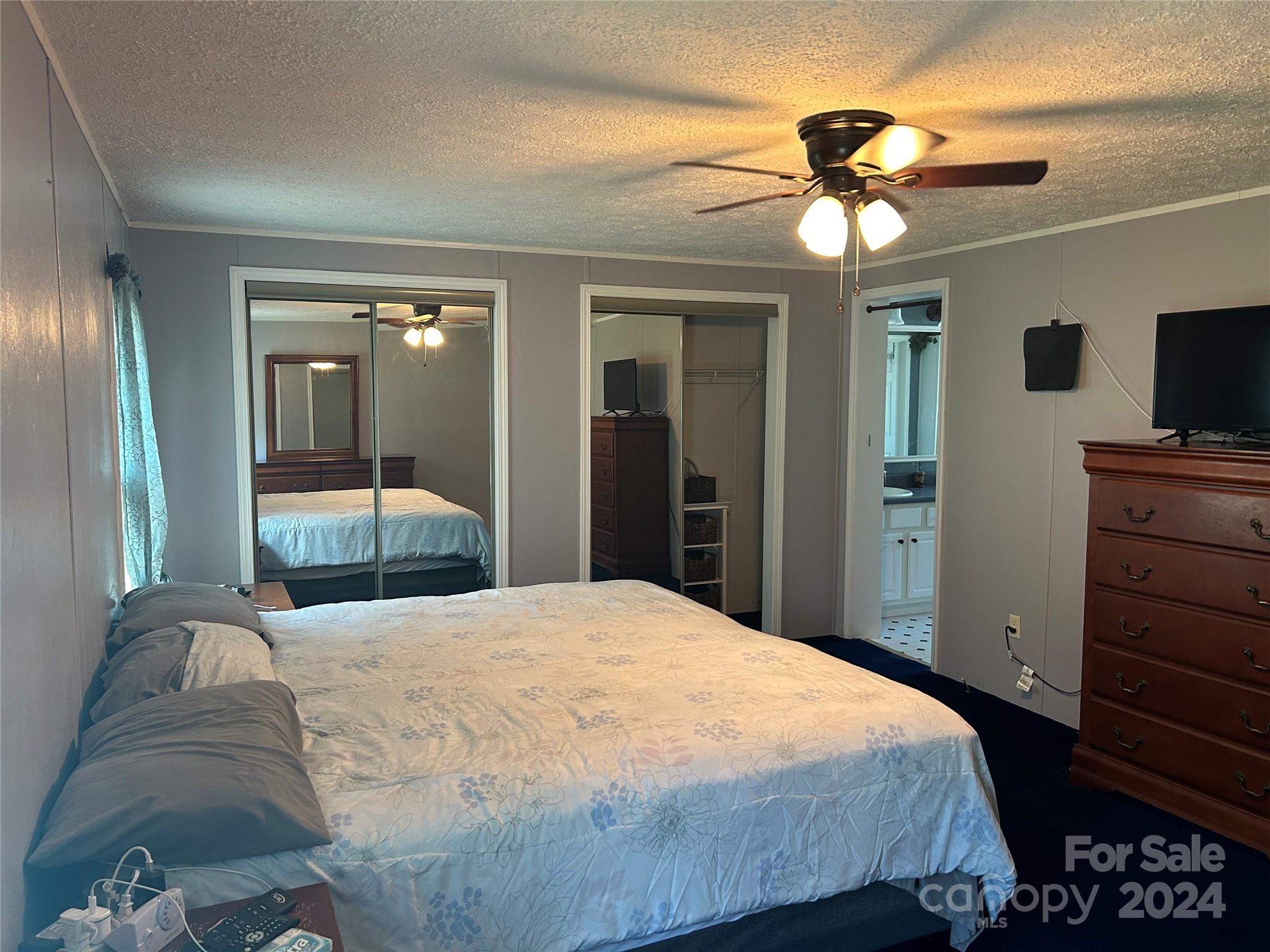 3250 Ferguson Long Road York, SC 29745 - Photo 22 of 32 a bedroom with a large bed and a chandelier