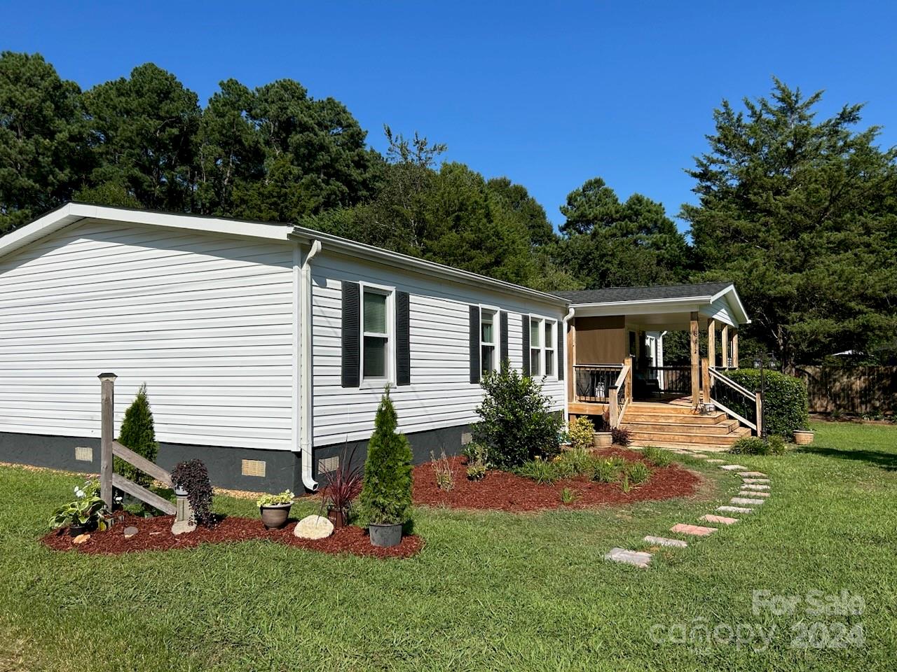 3250 Ferguson Long Road York, SC 29745 - Photo 3 of 32 a front view of house with a garden and trees