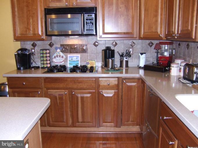 4401 Summer Grape Road, Unit 4401 Pikesville, MD 21208 - Photo 4 of 28 42" cherry cabinets, corian countertops