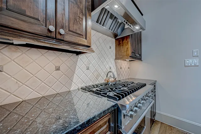 a kitchen with wooden cabinets and a stove top oven