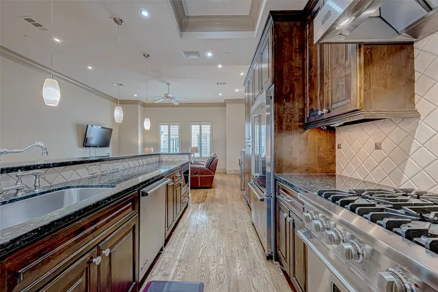 a spacious bathroom with a granite countertop sink a mirror and shower