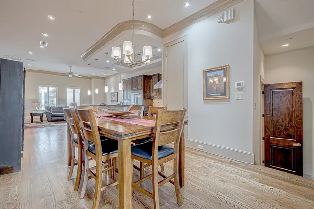 a view of a dining room with furniture and a chandelier