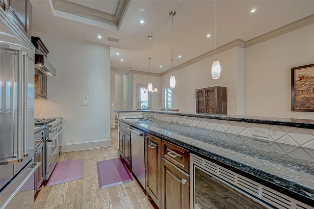 a kitchen with granite countertop a stove and a sink