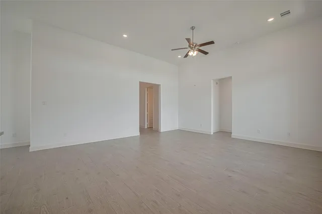 an empty room with fan and ceiling fan