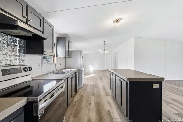 a kitchen with a sink stove and cabinets