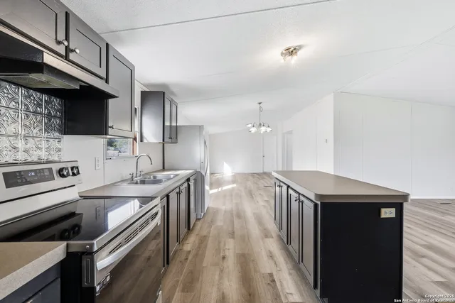 a kitchen with a sink stove and cabinets