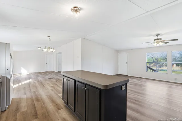 a kitchen with a wooden floor and window