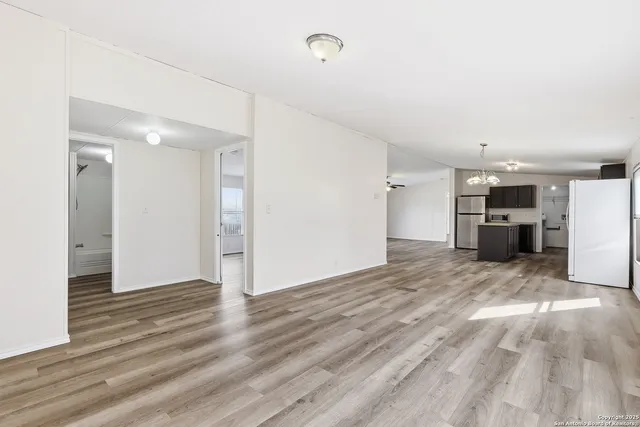 a view of a kitchen with a sink and a refrigerator