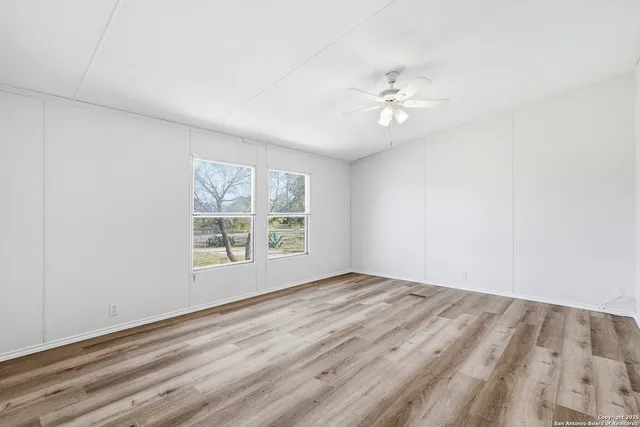 wooden floor in an empty room with a window